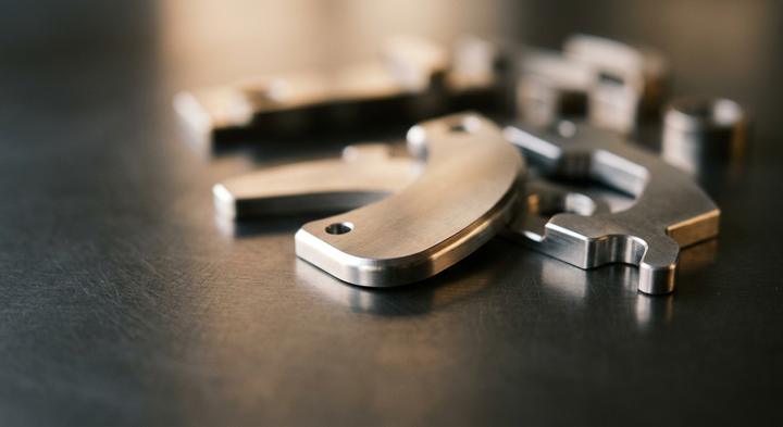 Close-up of clean-cut precision metal components showing smooth sheared edges