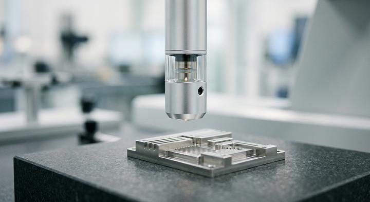 High-precision metrology laboratory setup with focus on a micro-fabricated metallic component under soft clinical lighting.