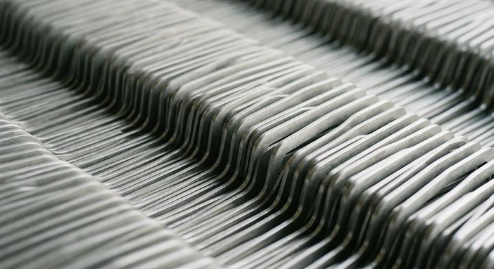 Abstract matte steel patterns representing structured technical audits in metal stamping