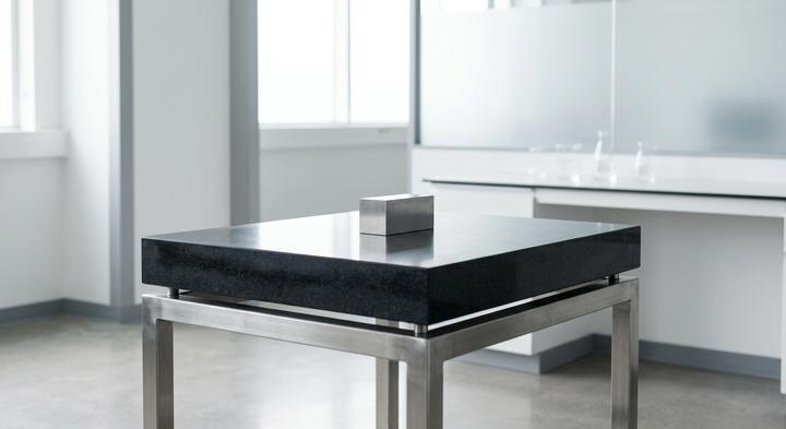 A pristine, climate-controlled quality control lab featuring a clean granite surface plate.